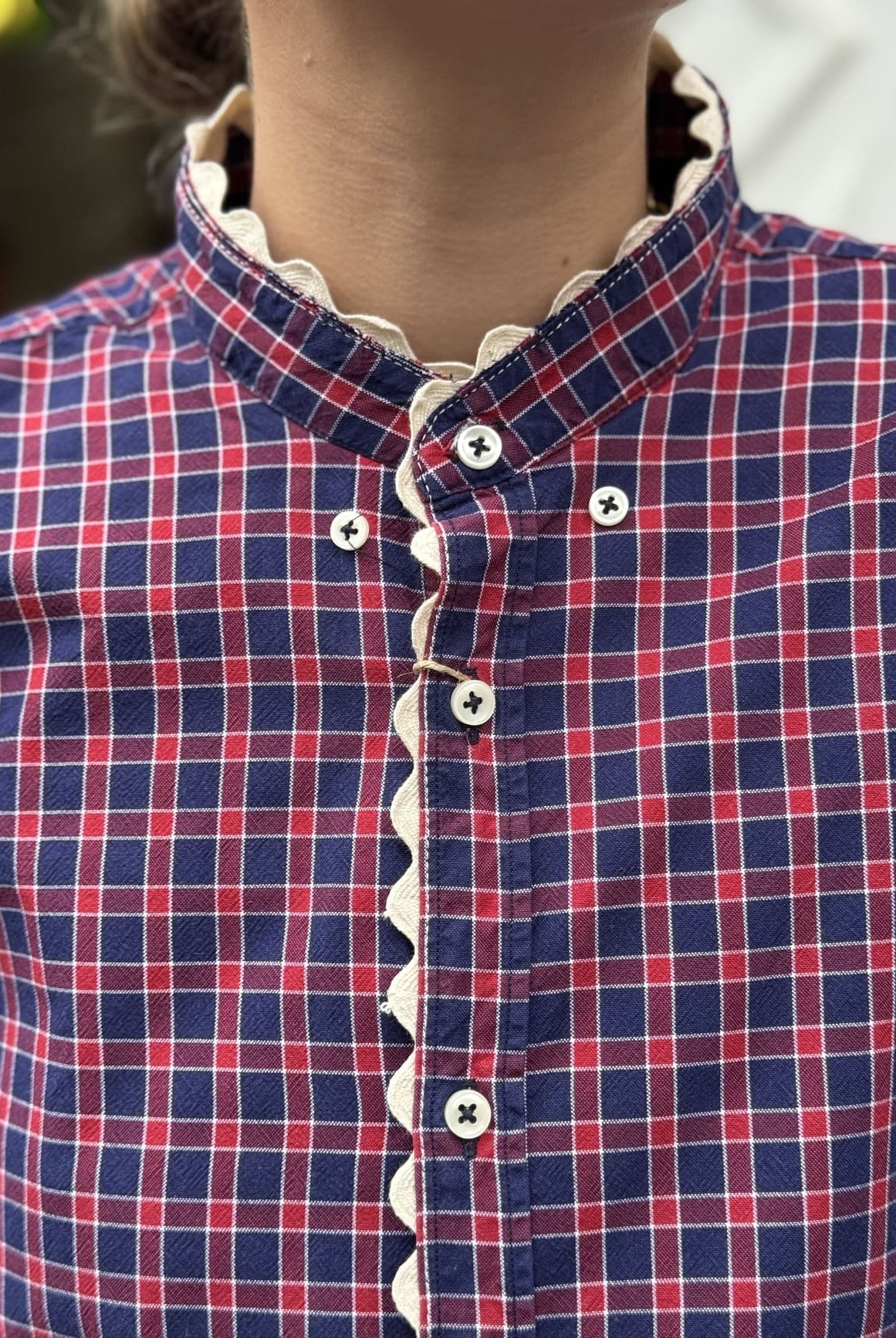 Détail motif écossais rouge & bleu et croquet blanc de la chemise