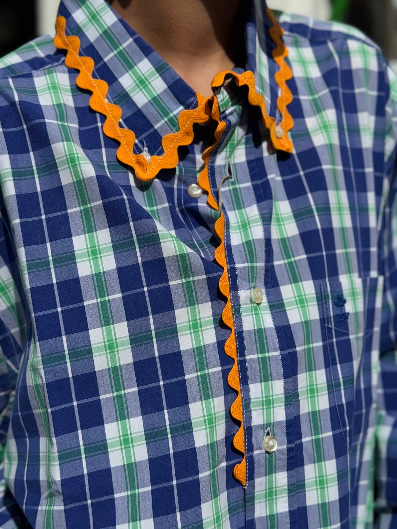 Détail du galon orange de la chemise upcyclée bleu et verte