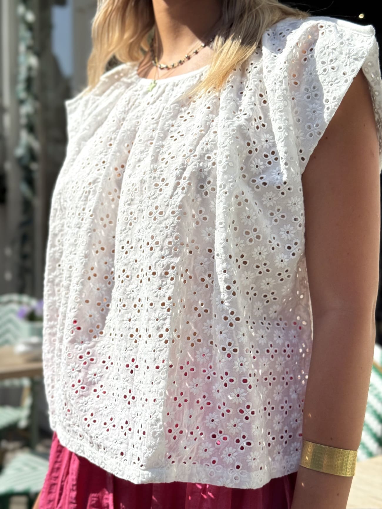 Vue de profil de la blouse en broderie anglaise sans manche