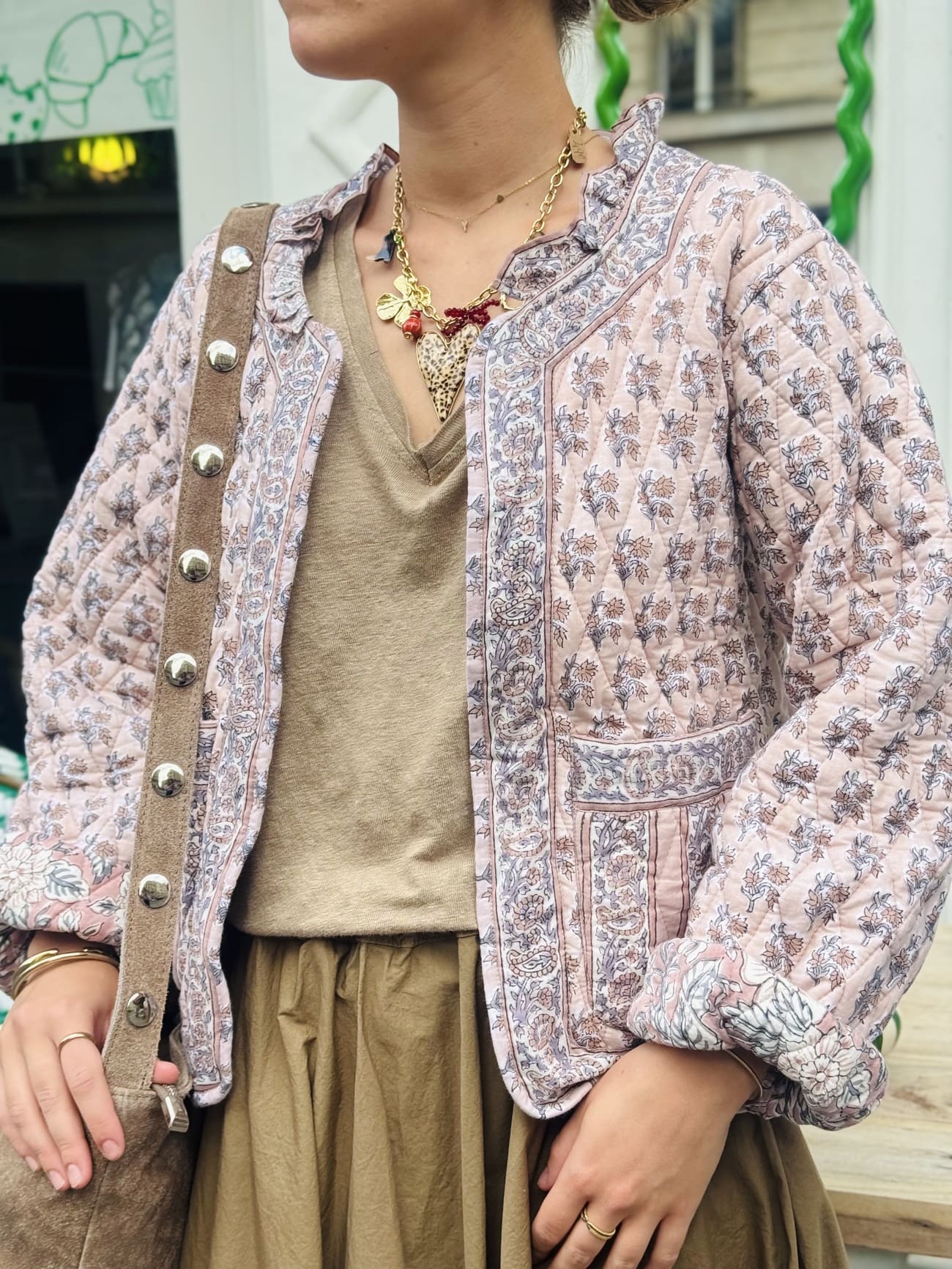 Plan américain sur une femme portant la veste matelassée en coton rose et beige pour femme